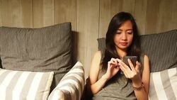 Asian woman text messaging Stock Footage