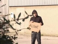 Hoody holding board saying &quot;ALONE&quot; - HD &amp; PAL Stock Footage