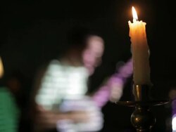 C/U candle (foreground), banjo player (background) Stock Footage