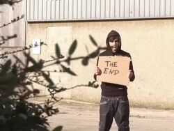 Youth / Hoody holding sign saying "The End" Stock Footage