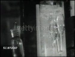 1937: MEDICAL RESEARCH: Two men in lab coats using microscopes. Researcher holding beaker & tubing up to bubbling tube. 'Hospital of the Rockefeller Institute' sign . Dr. Homer F. Swift working in laboratory (Rheumatic Fever & heart disease) Instructional Video