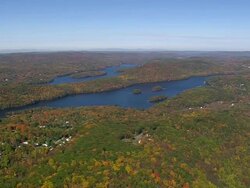 WS AERIAL PAN ZI View of covered island by Trees in fall colours near Candlewood Lake / Connecticut, United States Stock Footage