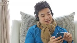 Teenager boy Enjoy Listening to Music on the sofa in relax time , Lifestyle and Relaxation concept , Panning left to right movement Stock Footage