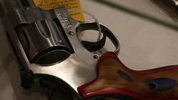 Pistols in a gun shop display cabinet News Clip