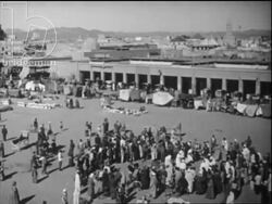 Streets of Marrakesh, street performer does trick with his eyes and some needles, men play traditional instruments. c.1960 Stock Footage