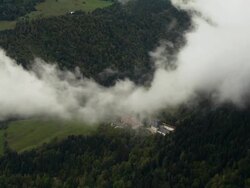 LOW AERIAL WS ZI Clouds revealing landscape and part of Grande Chartreuse Carthusian monastery in Chartreuse Mountains / Saint-Pierre-de-Chartreuse, Isere, France Stock Footage