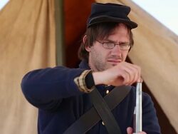 CU Shot of young man cleaning his gun and dressed in civil war costume / Santa Fe, New Mexico, United States Stock Footage
