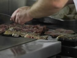 Close up shot of a chef grilling lamb and fish Stock Footage
