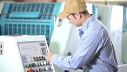 Man operating printing press, setting controls Stock Footage