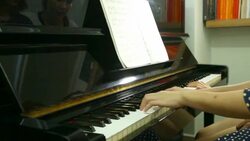 Pianist teacher teaching and playing music Stock Footage