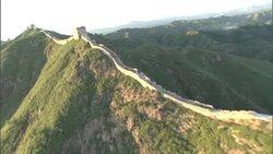 The Great Wall of China snakes across lush mountain ridges. Stock Footage