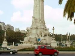 Statue with traffic on turnabout in Lisbon Portugal Stock Footage