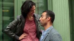 Young woman talks and laughs with boyfriend outside green Soho storefront Stock Footage
