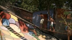 Brazilian street kids run and jump across swinging rope bridge in Rio de Janeiro Stock Footage