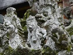 CU Stone figures and Macaque Monkeys in Pura Dalem Agung temple in Monkey Forest / Ubud, Bali, Indonesia Stock Footage