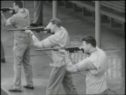 F.B.I. agents fire pistols at targets on an outdoor shooting range. News Clip