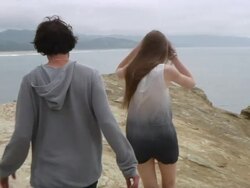 WS TS Couple walking on ridge with sea in background / Cape Kiwanda, Oregon, USA Stock Footage