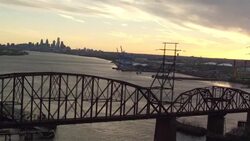 Aerial soaring over truss bridge on Delaware River looking toward Philadelphia skyline Stock Footage