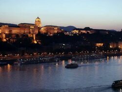 WS Boat on Danube River at twilight passing Buda side of Budapest / Budapest, Hungary Stock Footage
