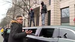 Rioters surrround badly damaged limousine News Clip