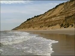 Waves lapping on sandy beach, Autumn, Parque Natural Donana, Andalusia, Southern Spain Stock Footage