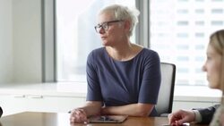MS Female business executive leading team meeting with colleagues in office conference room Stock Footage