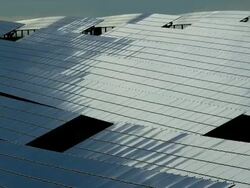HD TL Solar Panels Reflecting Moving Clouds (4:2:2@100 Mb/s) Stock Footage