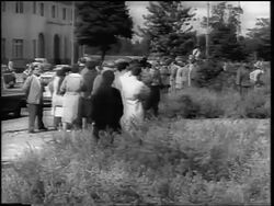 B/W 1961 PAN from crowd of West Germans to barbed wire fence of Berlin Wall / newsreel Stock Footage