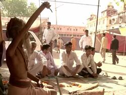 Sadhu sitting next to barrack Stock Footage