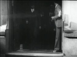 B/W 1930 police with Legs Diamond exiting building Stock Footage