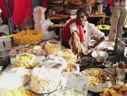 MS Shot of Locals buying prepared food at local market food stall / Pushkar, Rajasthan, India  Stock Footage