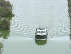 MS AERIAL TU Shot of motorboat in river at Carnon Plage / Languedoc Roussillon, France Stock Footage