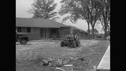 WS Tractor ploughing garden in suburban house contruction site / United States Stock Footage