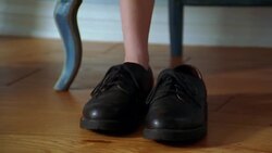 A child steps into a pair of men's shoes and walks. Stock Footage