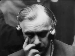 B/W 1945/46 close up worried Alfred Rosenberg with headphones at war crime trials / Nuremberg / documentary Stock Footage