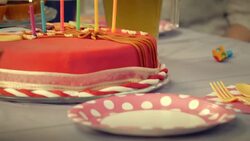 Party table and birthday cake with lit candles on it Stock Footage