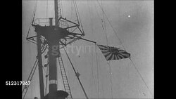 1939: JAPAN NAVY PATROL: WS Japanese Navy battleship in harbor. WS Japanese flag on crow's nest. HA WS Launch boat approaching ship. MS Naval officer. CU Sailors. MS Naval officers looking over map plans. China Instructional Video
