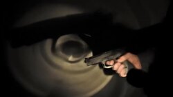 hand holding a gun and pulling the trigger Stock Footage
