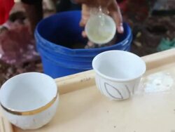 Ethiopian woman rinsing coffee cups Stock Footage