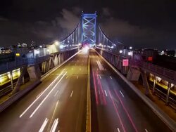 Night time, time lapse of Philadelphia cityscape, overhead shot traffic crosses the Ben Franklin Bridge. Stock Footage