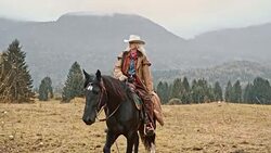 SLO MO Cowgirl riding her horse on mountain Stock Footage