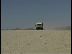 MS Zoom out, Truck driving along dusty track, Namibia Stock Footage