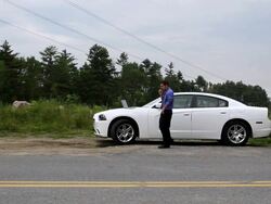 WS Man talking on bluetooth beside car / Portland, ME, United States Stock Footage