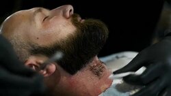 Close-up of beautiful attractive adult man with beard in a barber shop Stock Footage
