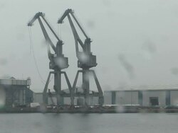 WS Crane towers are demolished using explosives and collapse into  shipping canal  / Liverpool, NorthWest England, UK Stock Footage