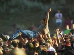 crowd of people at a Hindu festival throwing a young man into the air Stock Footage