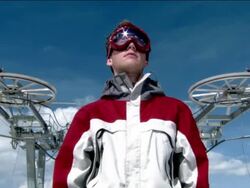 Low angle medium shot portrait of male snowboarder / zoom in close up reflection of mountain in goggles / Morzine, France Stock Footage