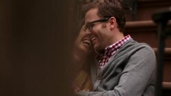 New York couple laugh and snuggle close on stoop of brownstone apartment (dolly-shot) Stock Footage