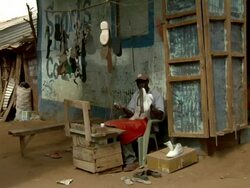 Cobbler rubbing white tennis shoes Stock Footage