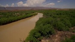 Fly low along Rio Grande River from Big Bend National Park Texas looking at Mexico Stock Footage